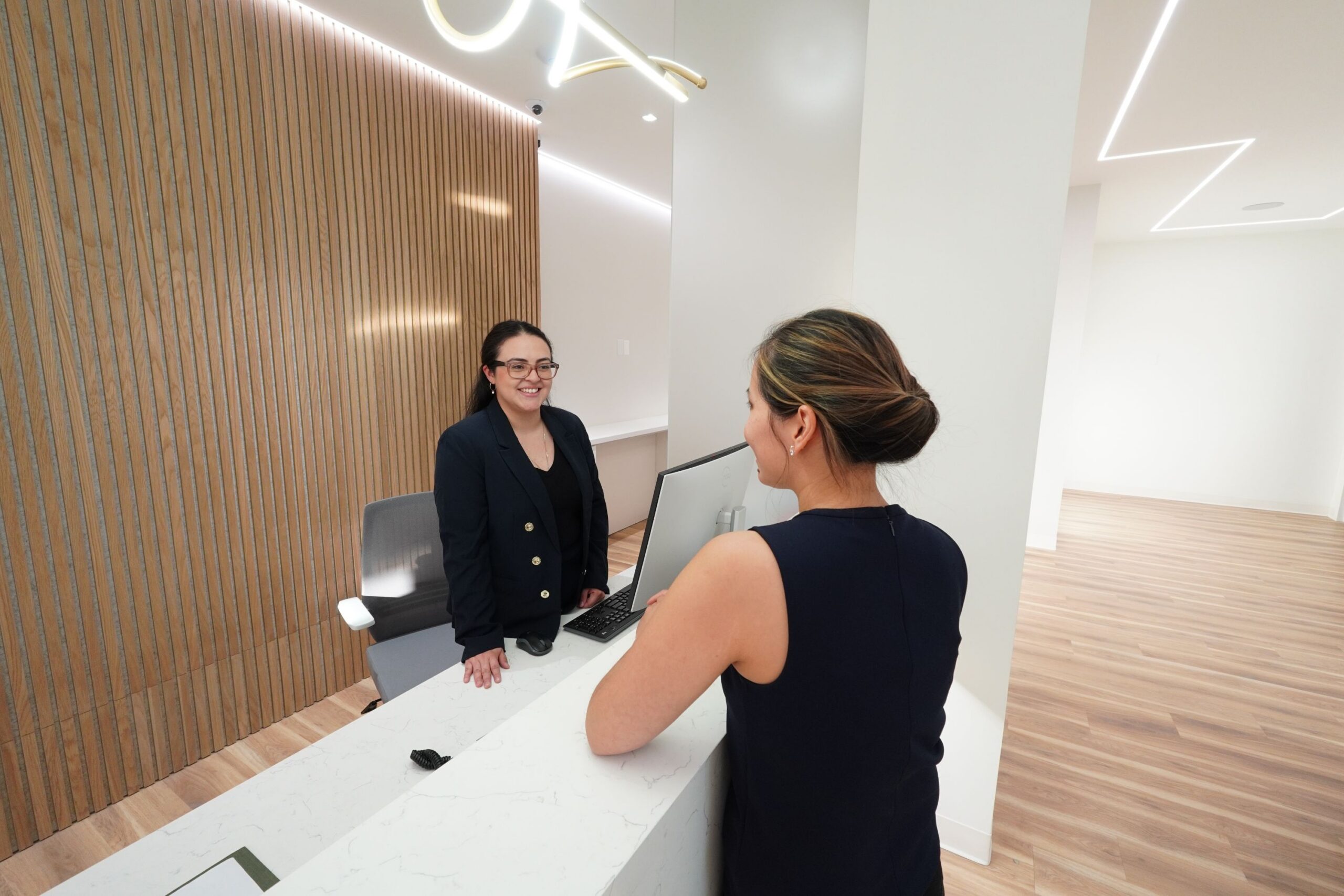 Two ladies talking at the front desk of Smile on Westbury